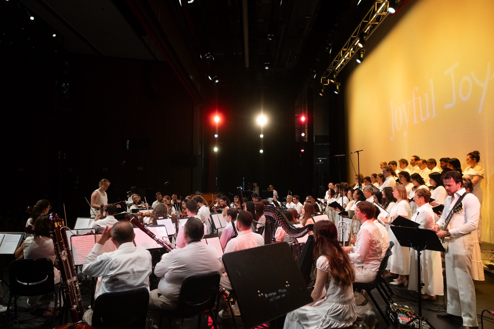 AChA orchestra and choir performing at a formal concert