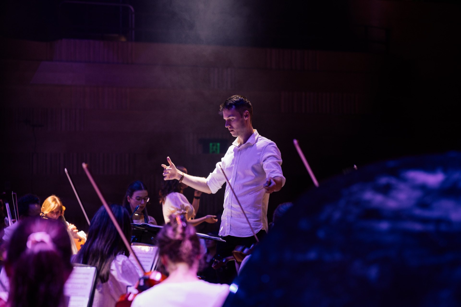 Conductor leading the Australian Christian Orchestra at an Easter concert