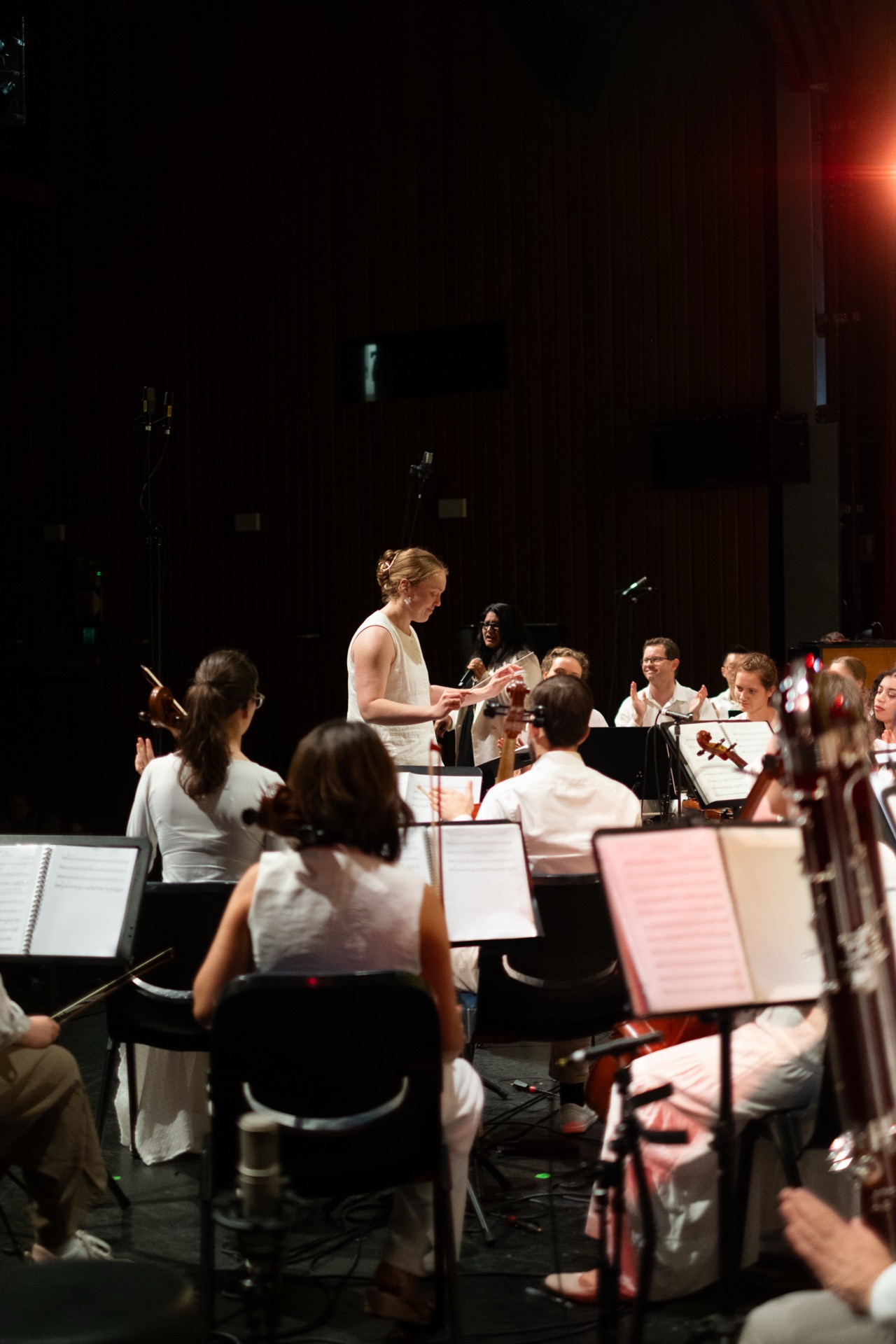 AChA musicians rehearsing with their conductor