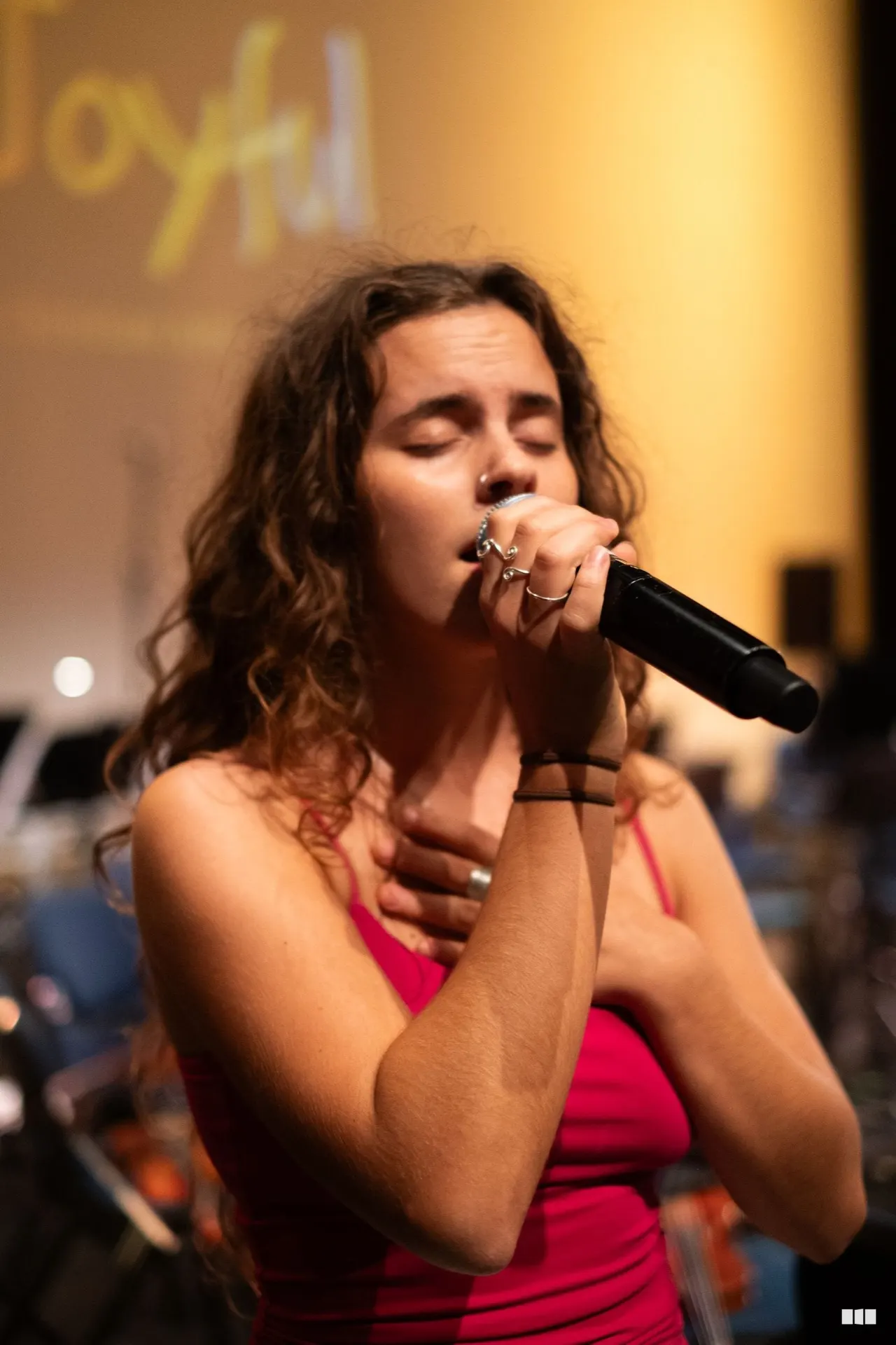 Soloist singing with hand on heart during a Christian Choir Sydney performance