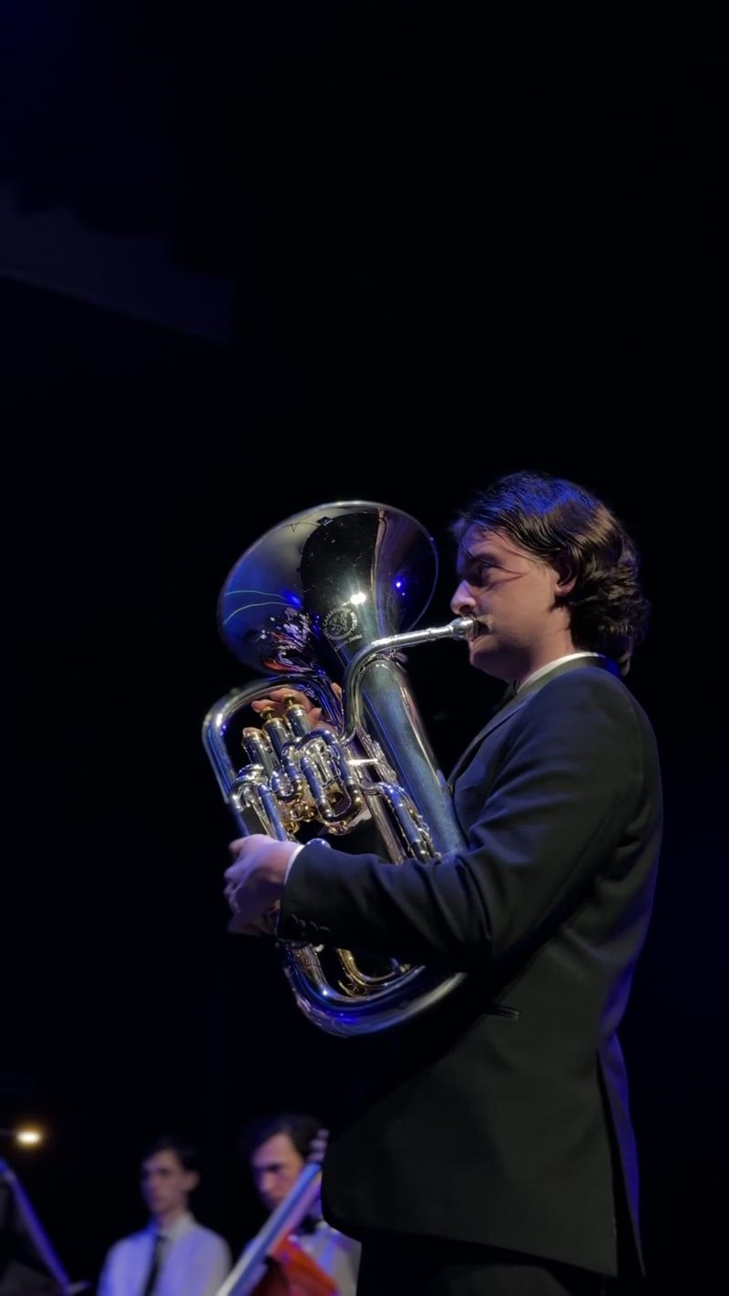 A musician performing on stage with a tuba.
